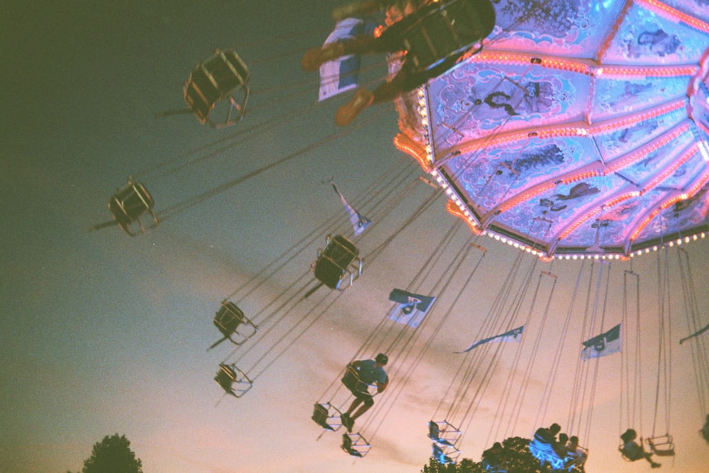 people riding amusement ride during night time