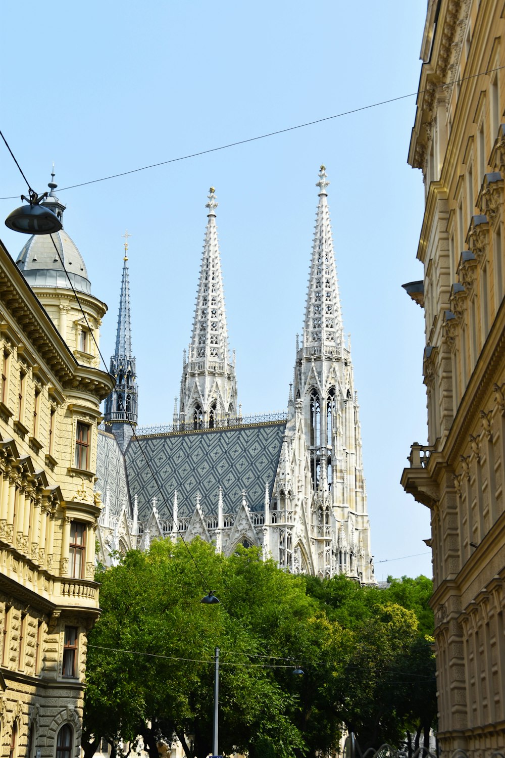 a large cathedral towering over a city filled with tall buildings