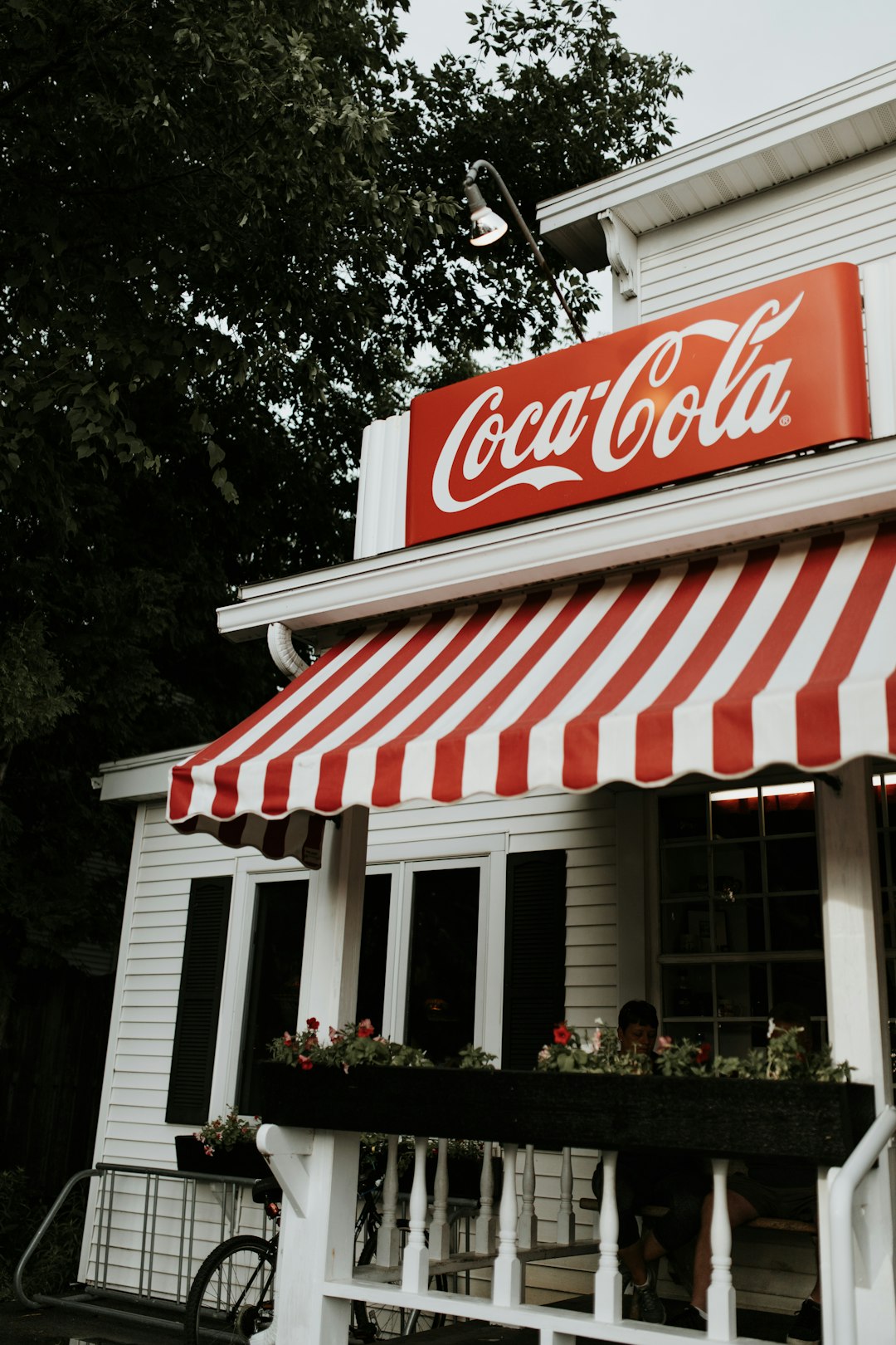 Coca-Cola signage and red and white striped awning