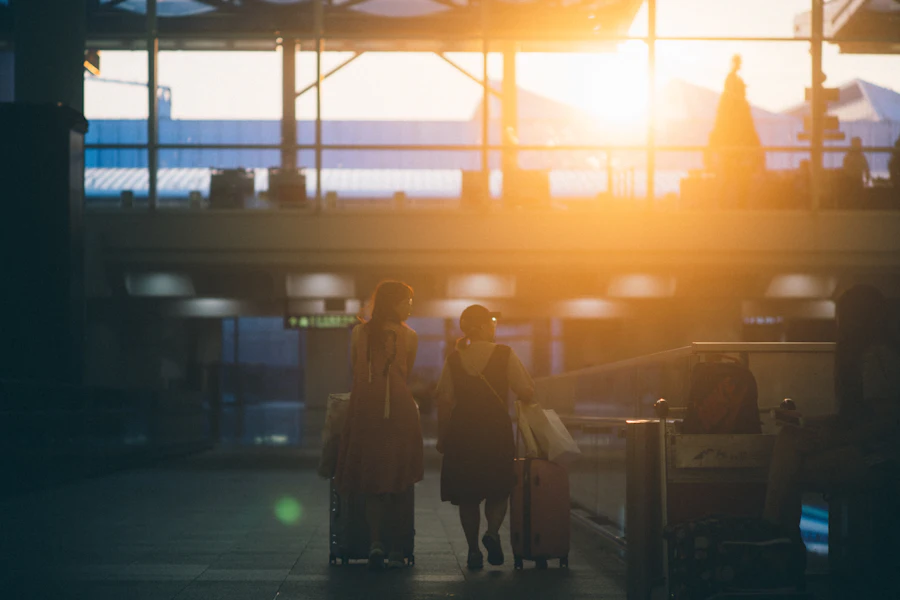 Travellers walking through an airport with luggage
