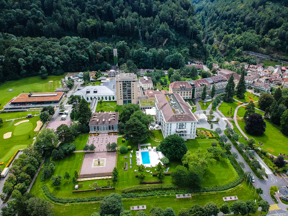 aerial photo of buildings surrounded by grass and trees