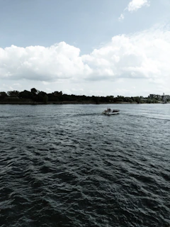 The White Nile flowing gently through green banks near Juba, with fishing boats on the water.