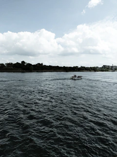 The White Nile flowing gently through green banks near Juba, with fishing boats on the water.