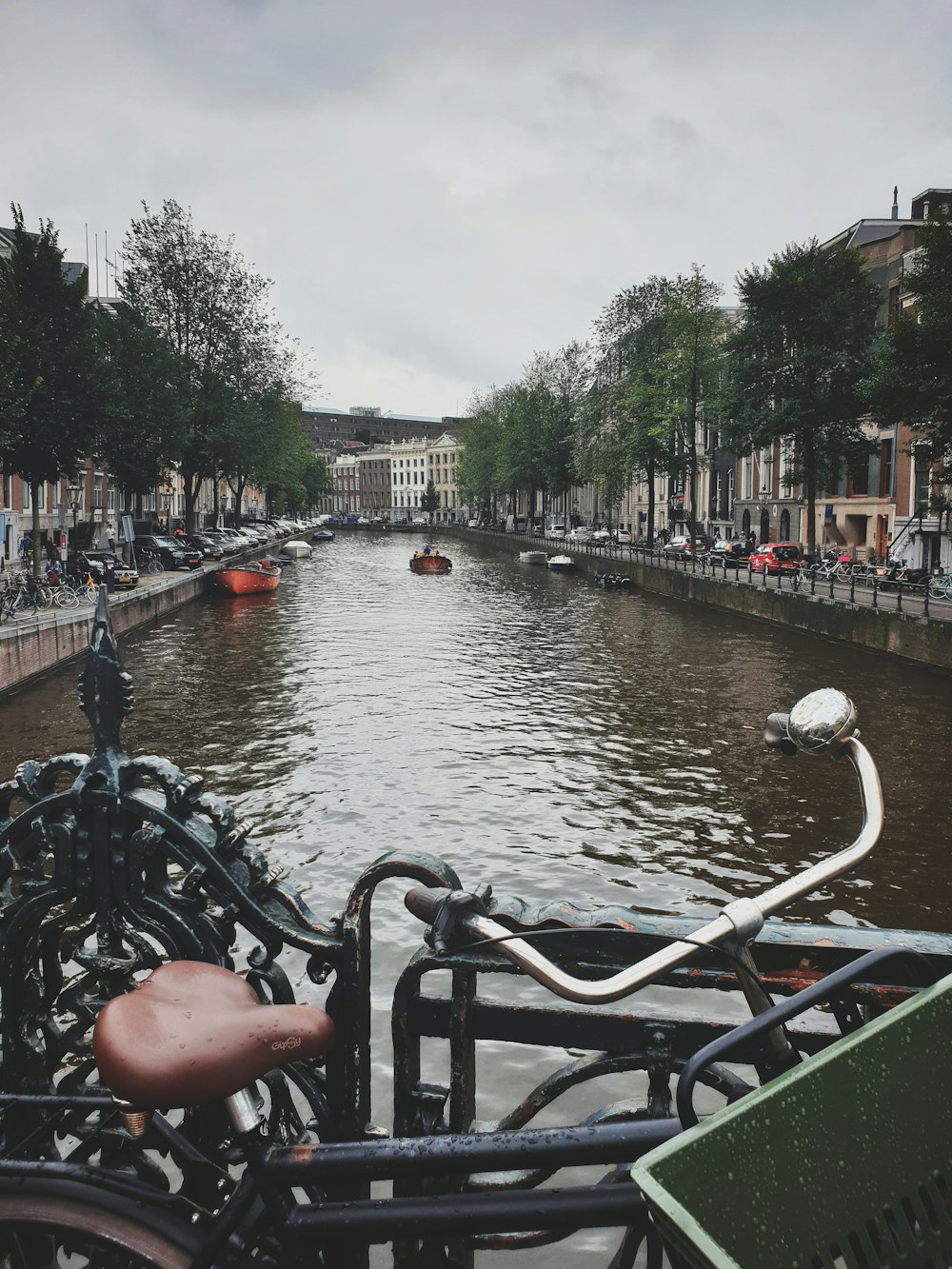 bici da città nera parcheggiata vicino a uno specchio d'acqua durante il giorno