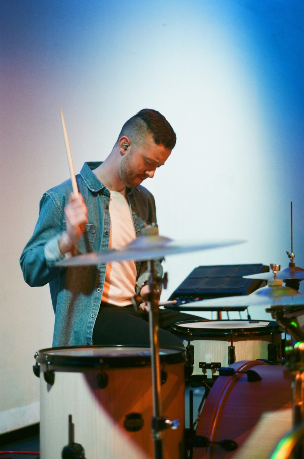man about to strike drumstick on the drums