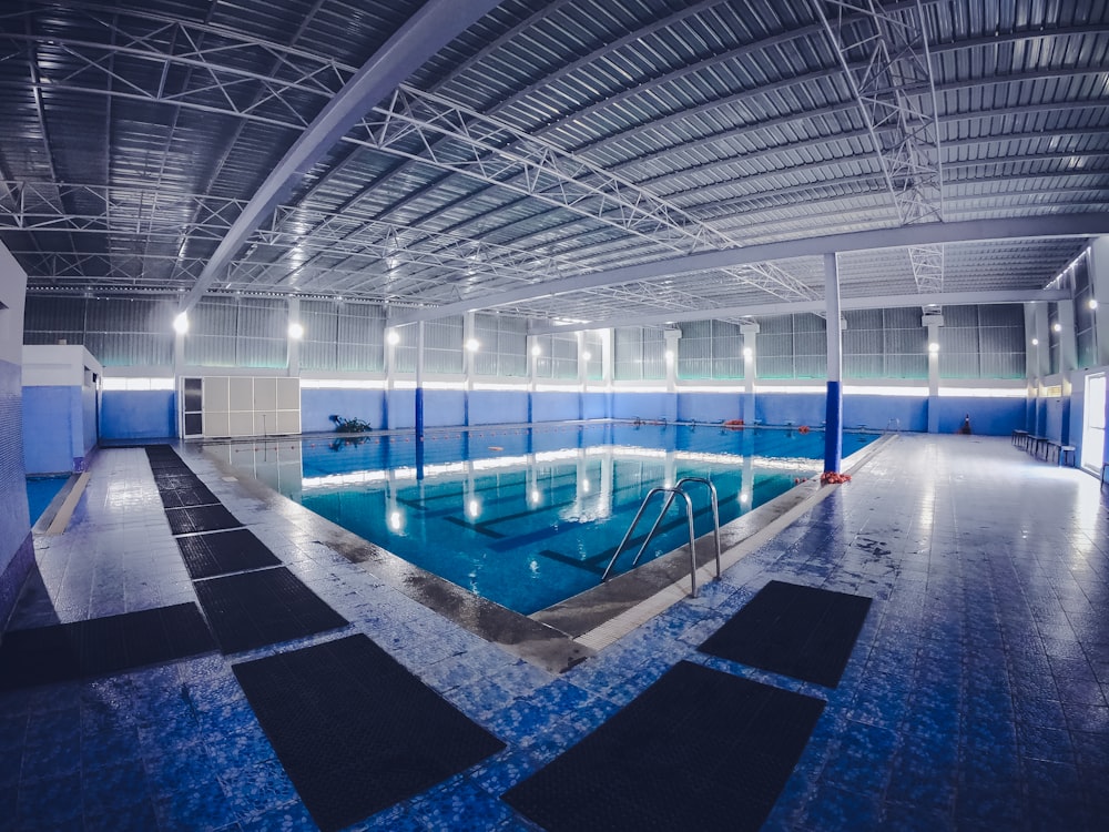 rectangular blue swimming pool inside building