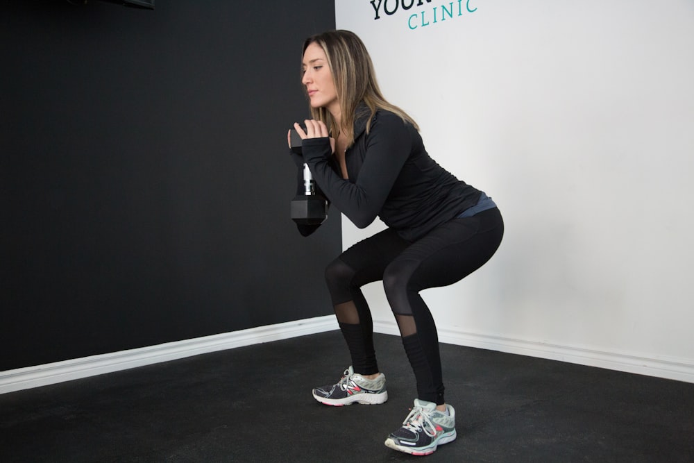 woman holding dumbbell