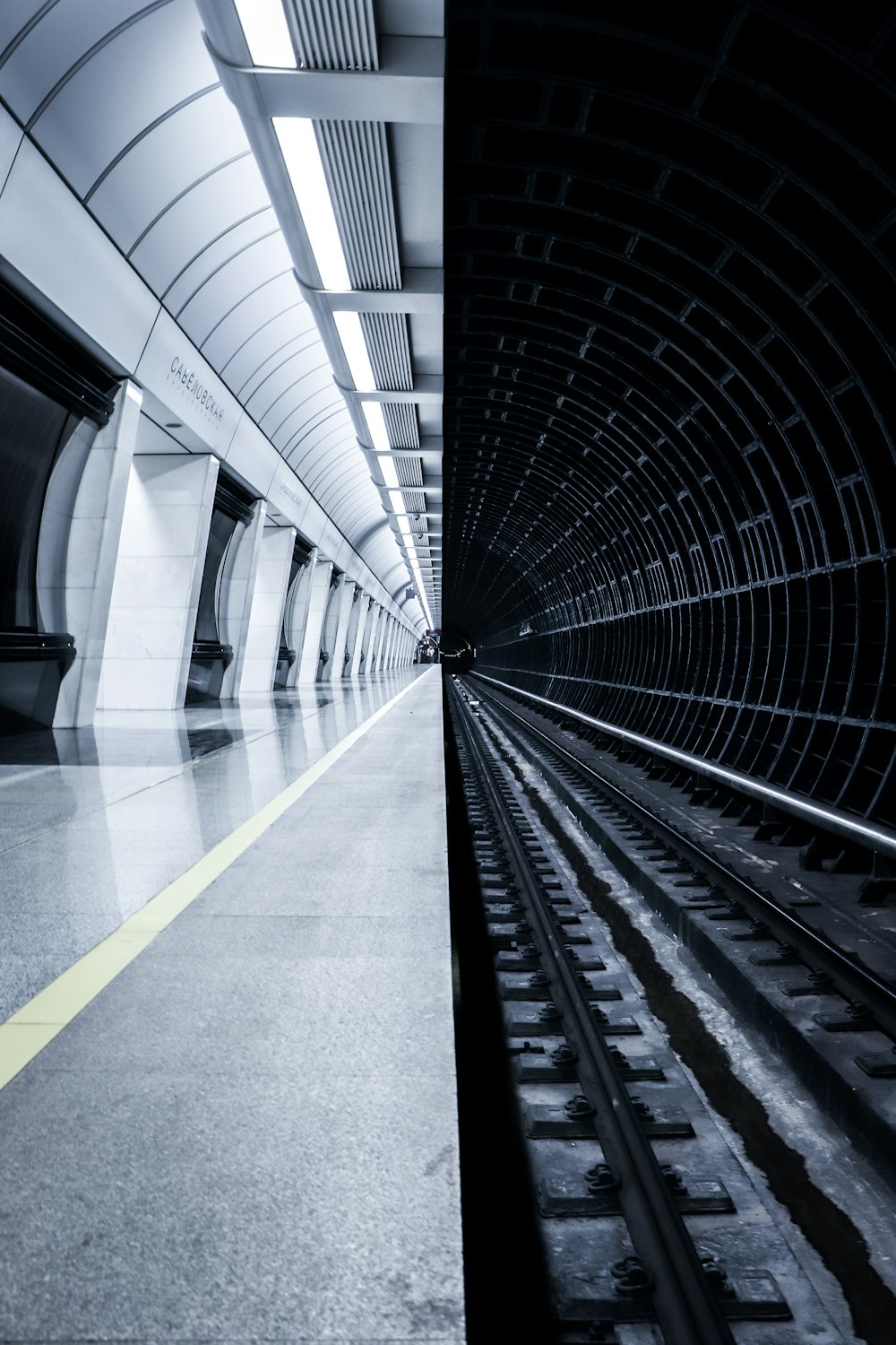 grayscale photography of train station with no people