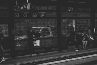 A photo showcasing a local bus stop with commuters waiting.