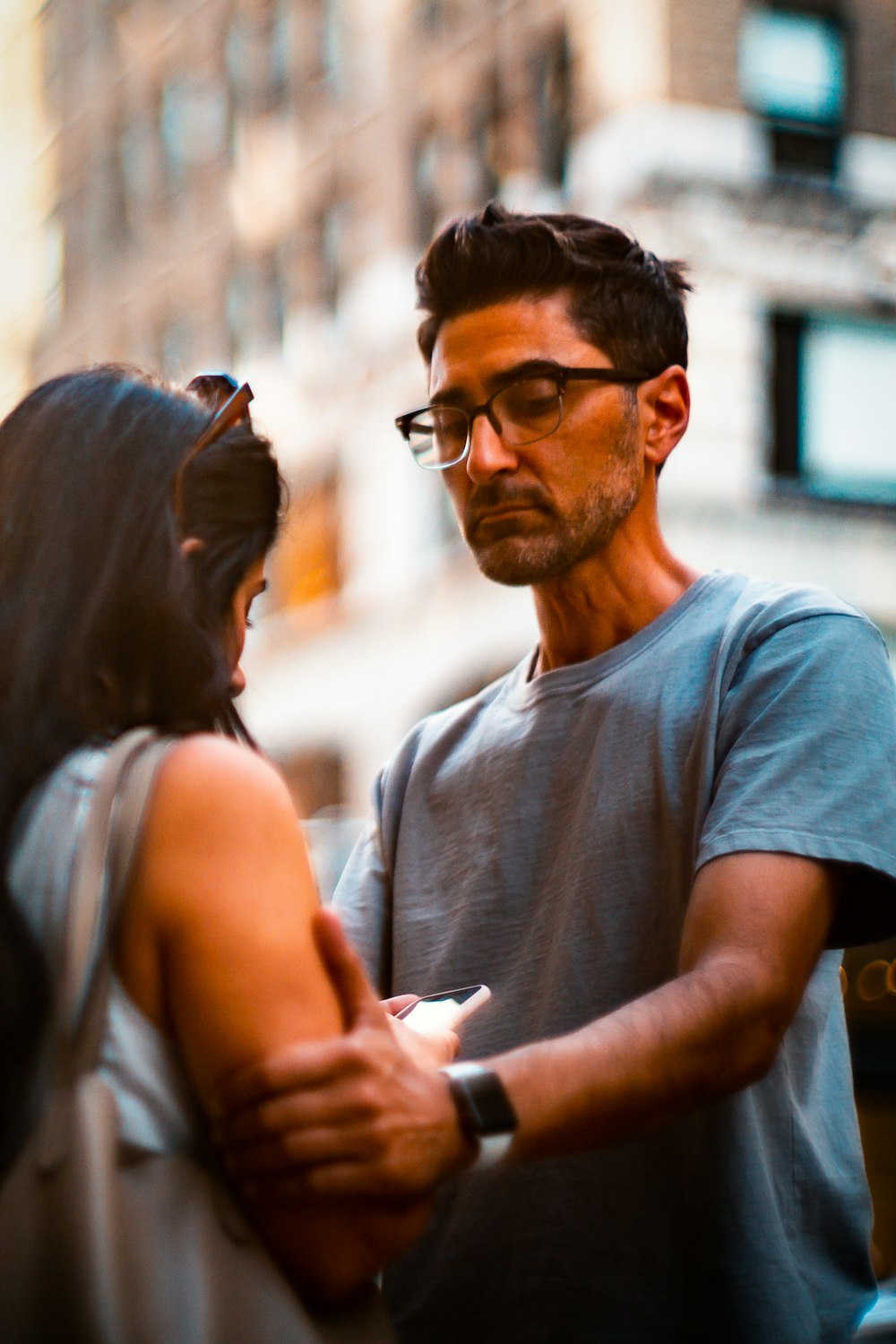 man holding woman's shoulder