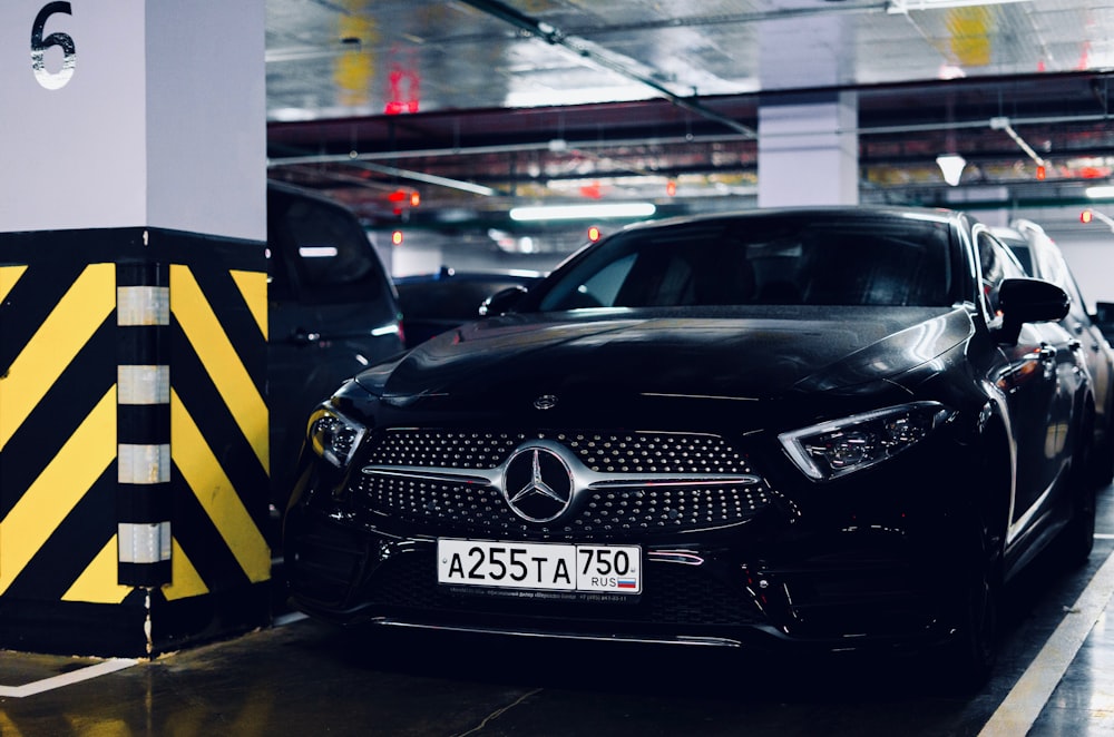 black Mercedes-Benz vehicle parking in garage