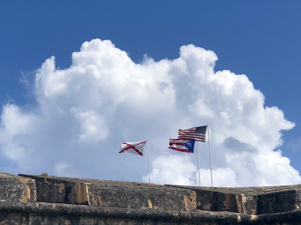 three assorted-color nation flags