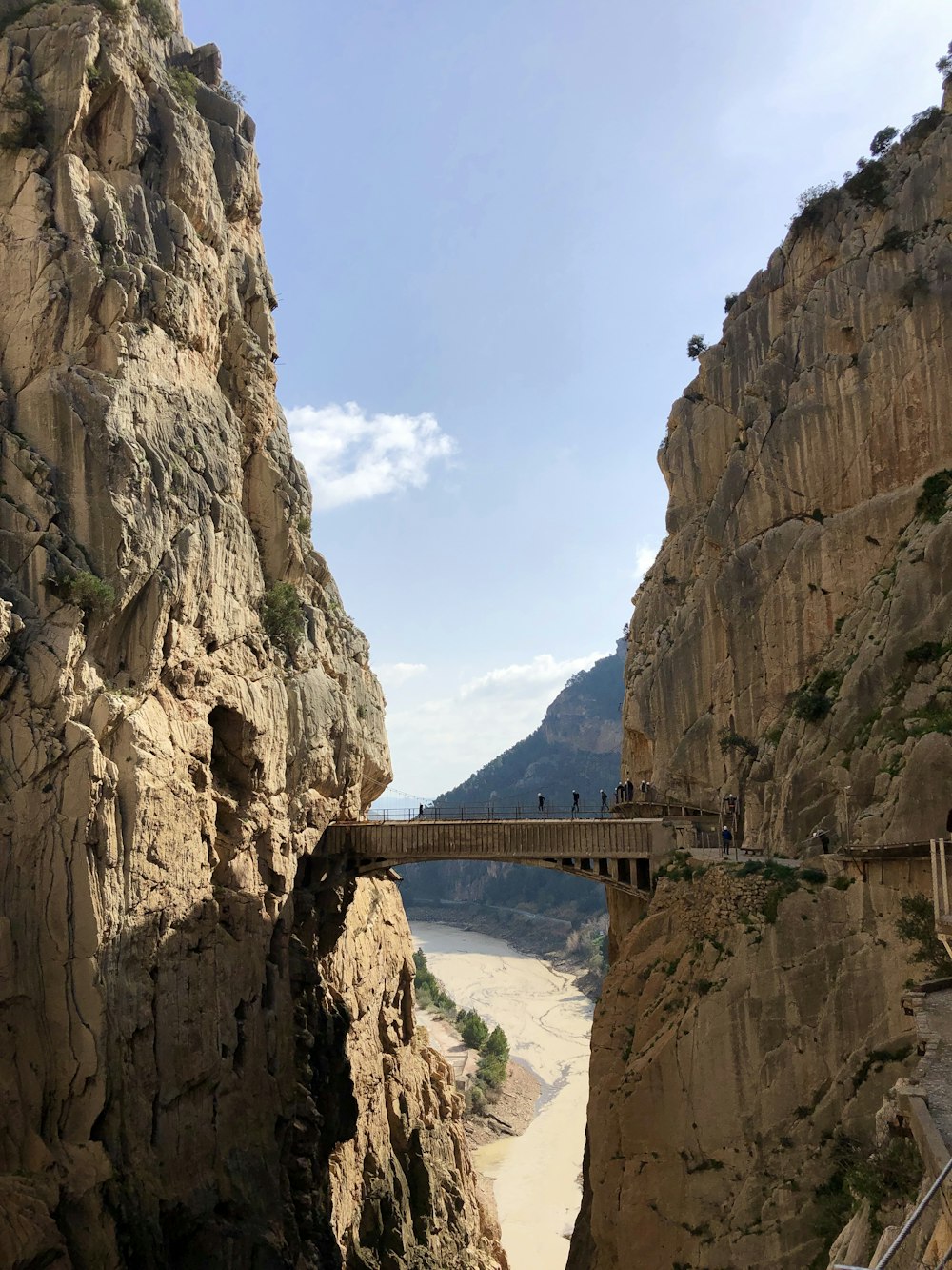 gray bridge between mountains during daytime