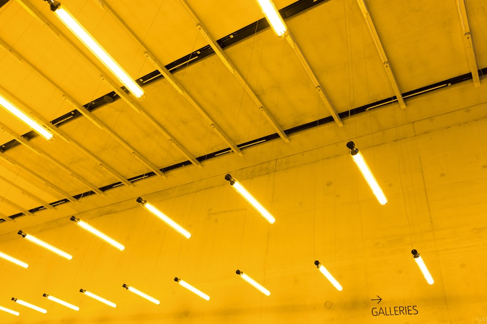 a yellow ceiling with lights hanging from it