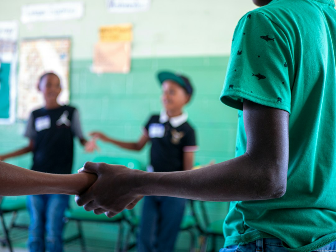 Members of a nonprofit organization hold hands in a circle.