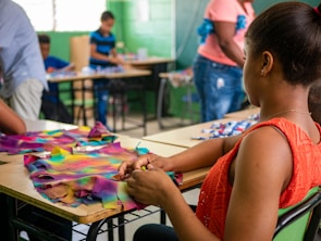 Instructor guiding a small class through a creative project in a bright classroom