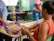 A diverse group of students collaborating on a project in a bright classroom.