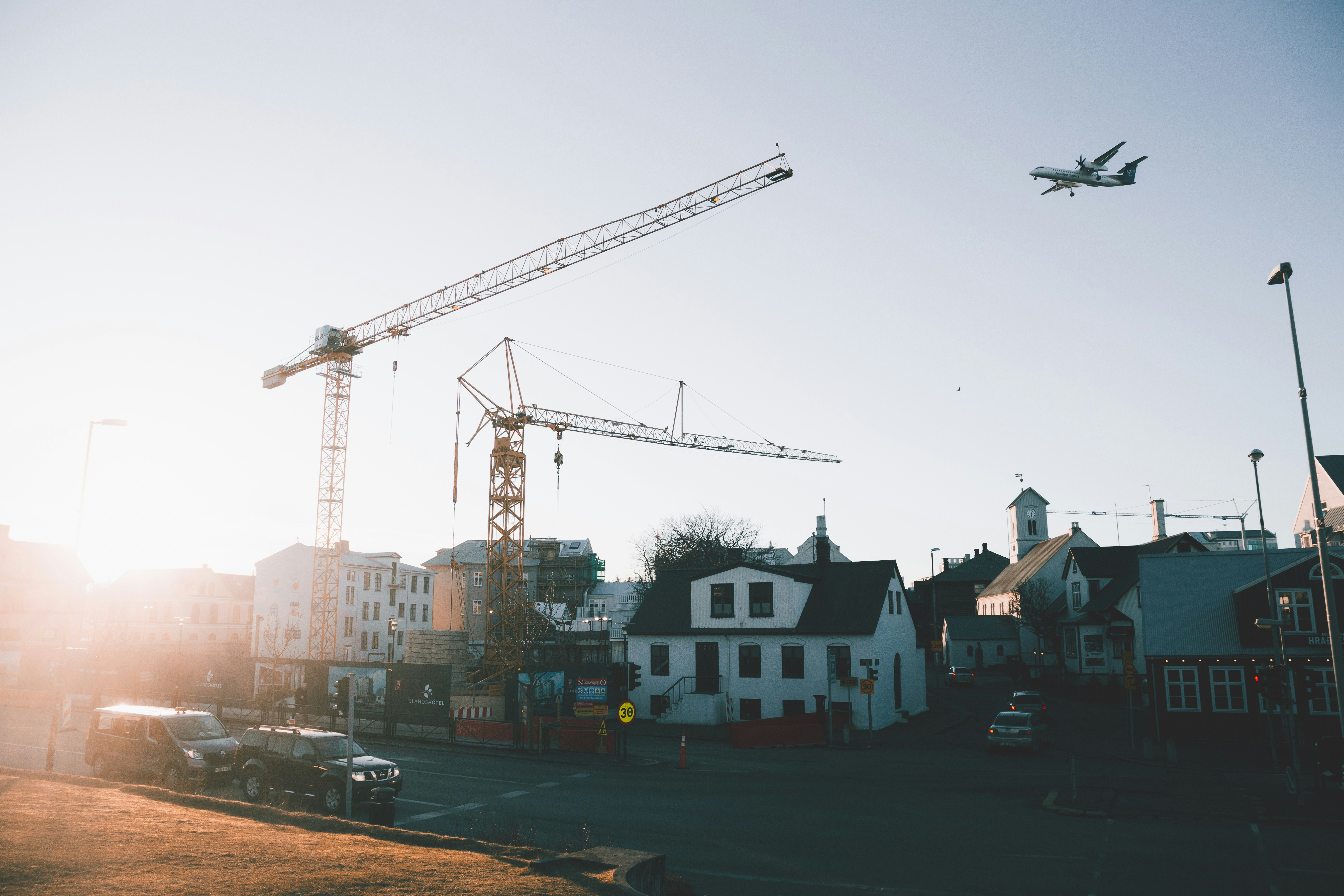 a plane is flying over a construction site