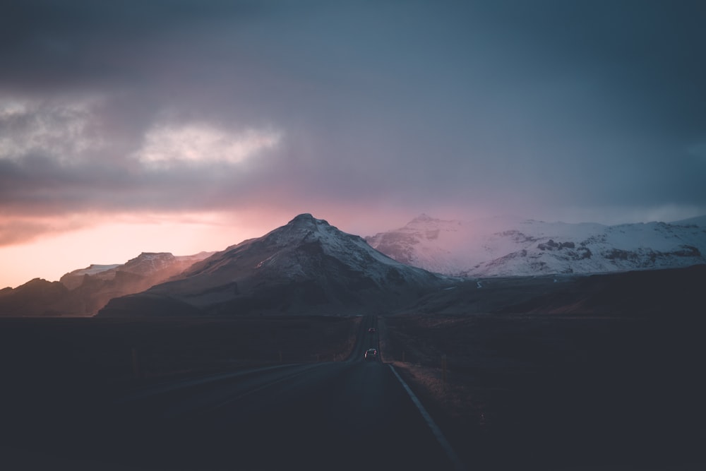 car on road under grey sky