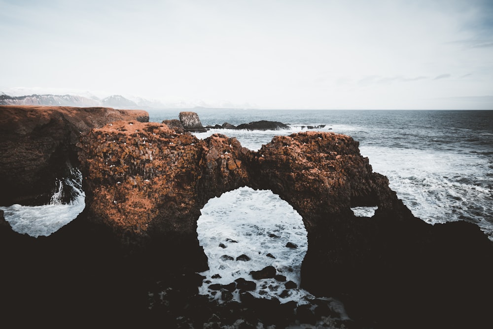 a rock formation in the middle of a body of water