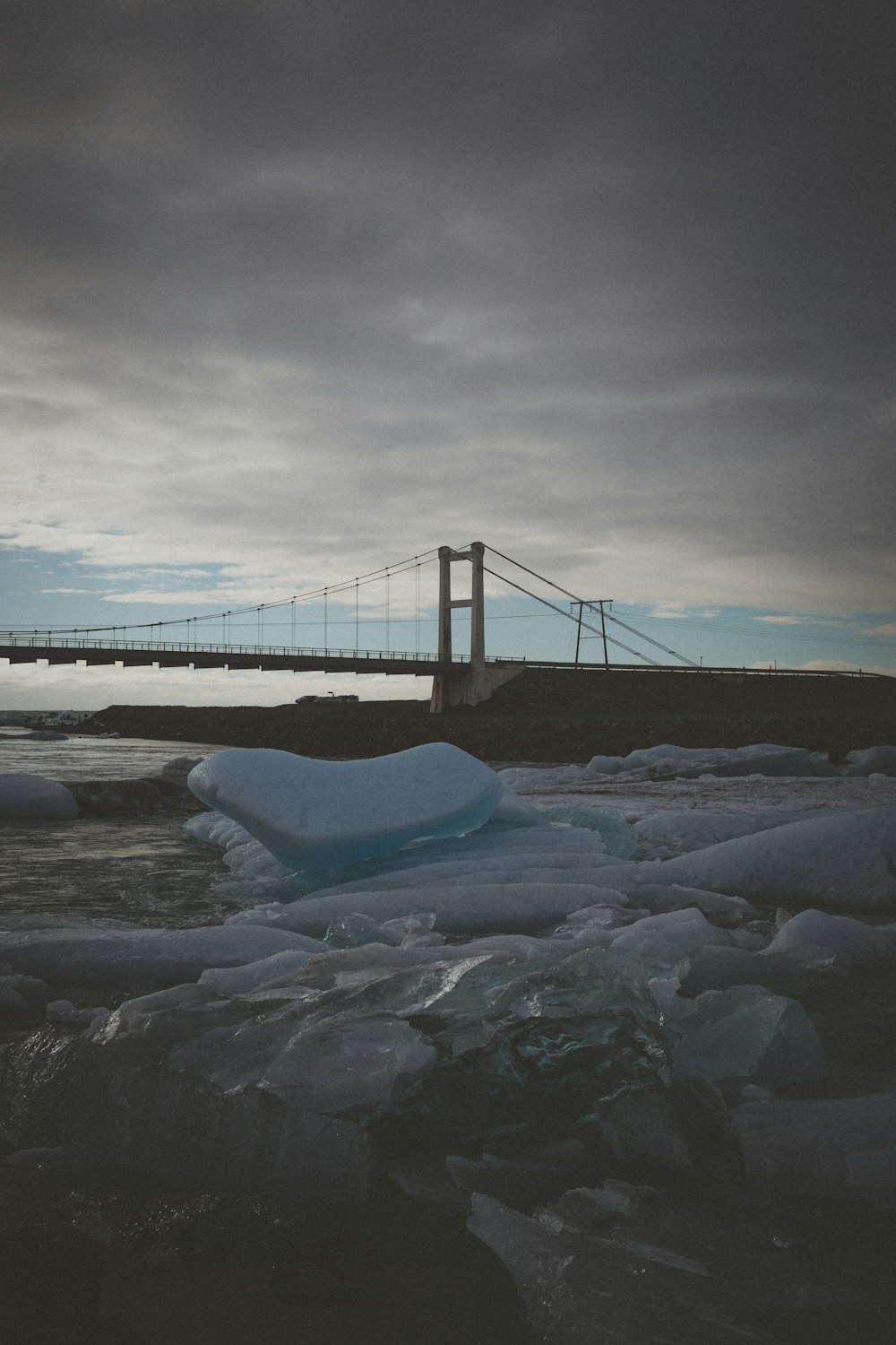 cable stayed bridge under cloudy sky