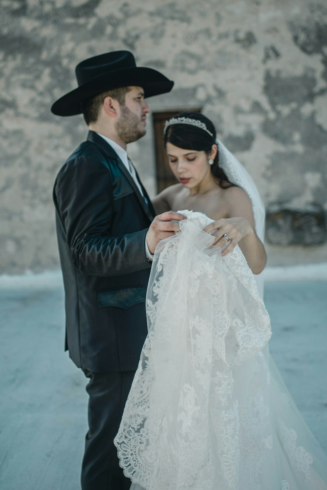 man and woman standing facing each other near wall