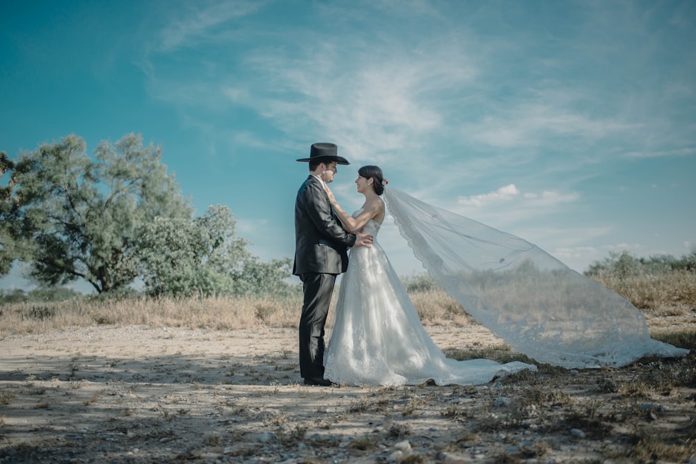 man and woman standing near trees at daytime