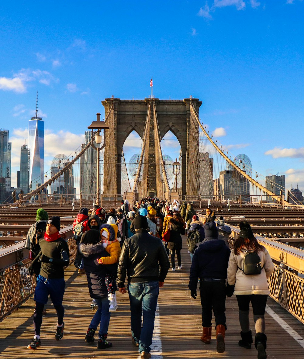 people crossing on bridge