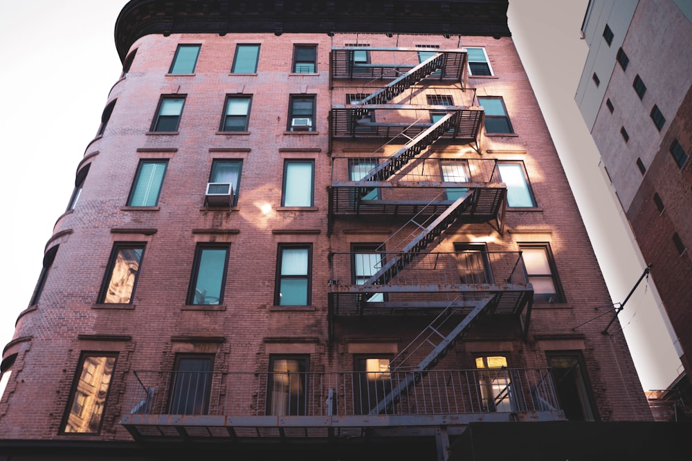 brown mid rise building with fire exit stairs