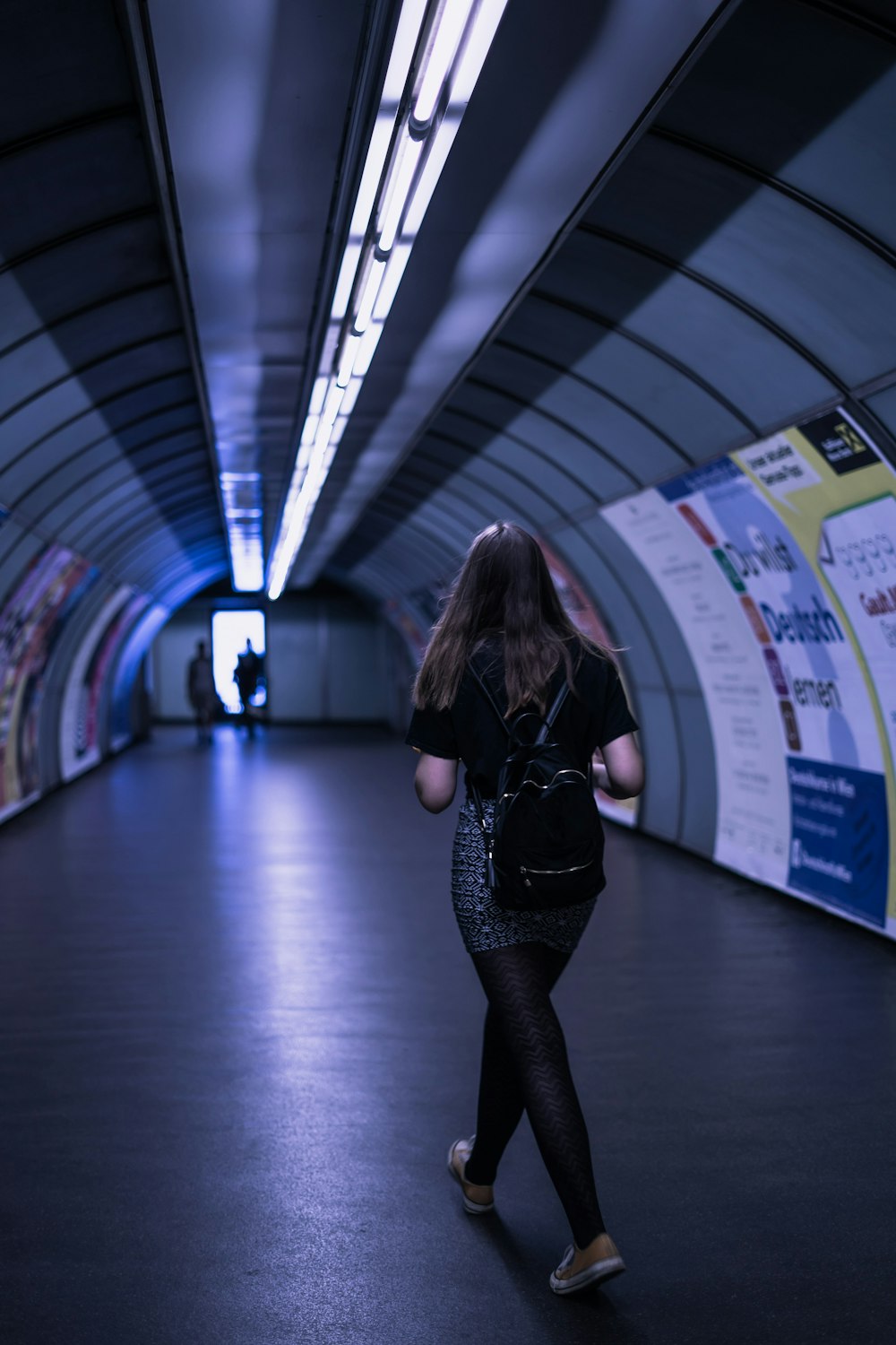 woman walking on tunnel