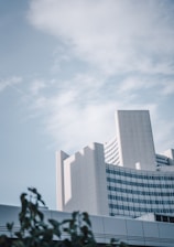 Modern office building exterior with clear blue sky background.