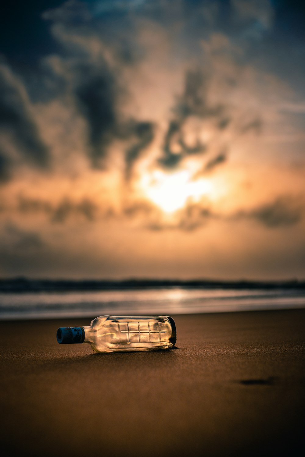 brown bottle on seashore