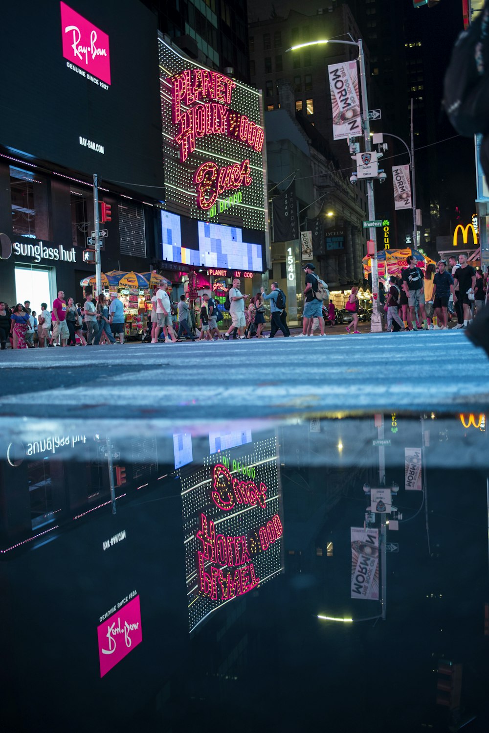 a group of people walking down a street at night