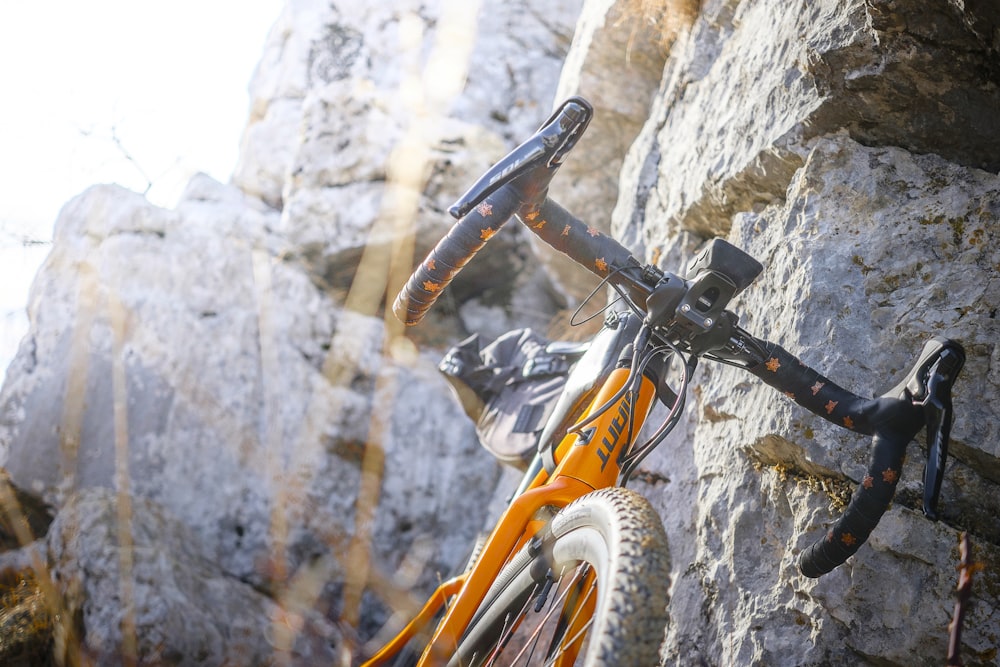 bicycle leaning on rock formation