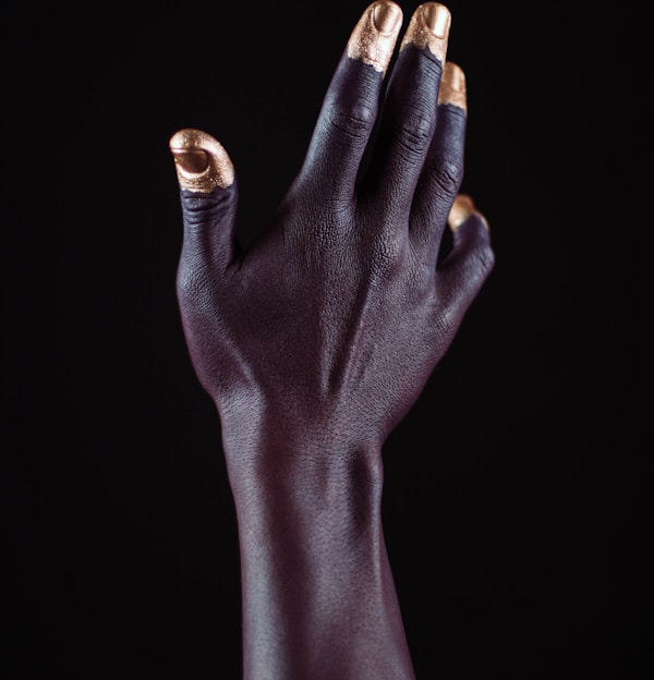 gold-dipped person's fingers