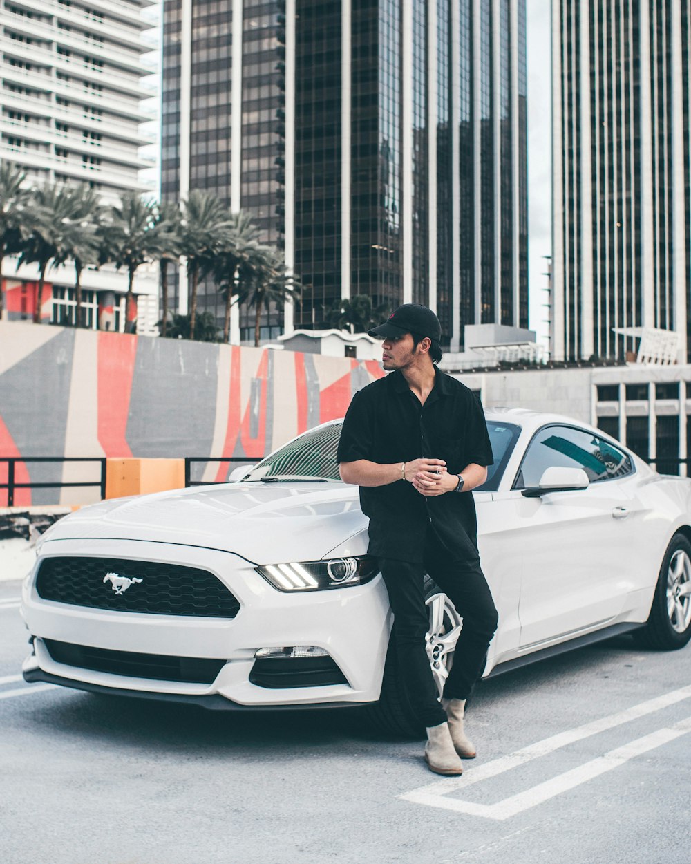 man stand near the white Ford mustang