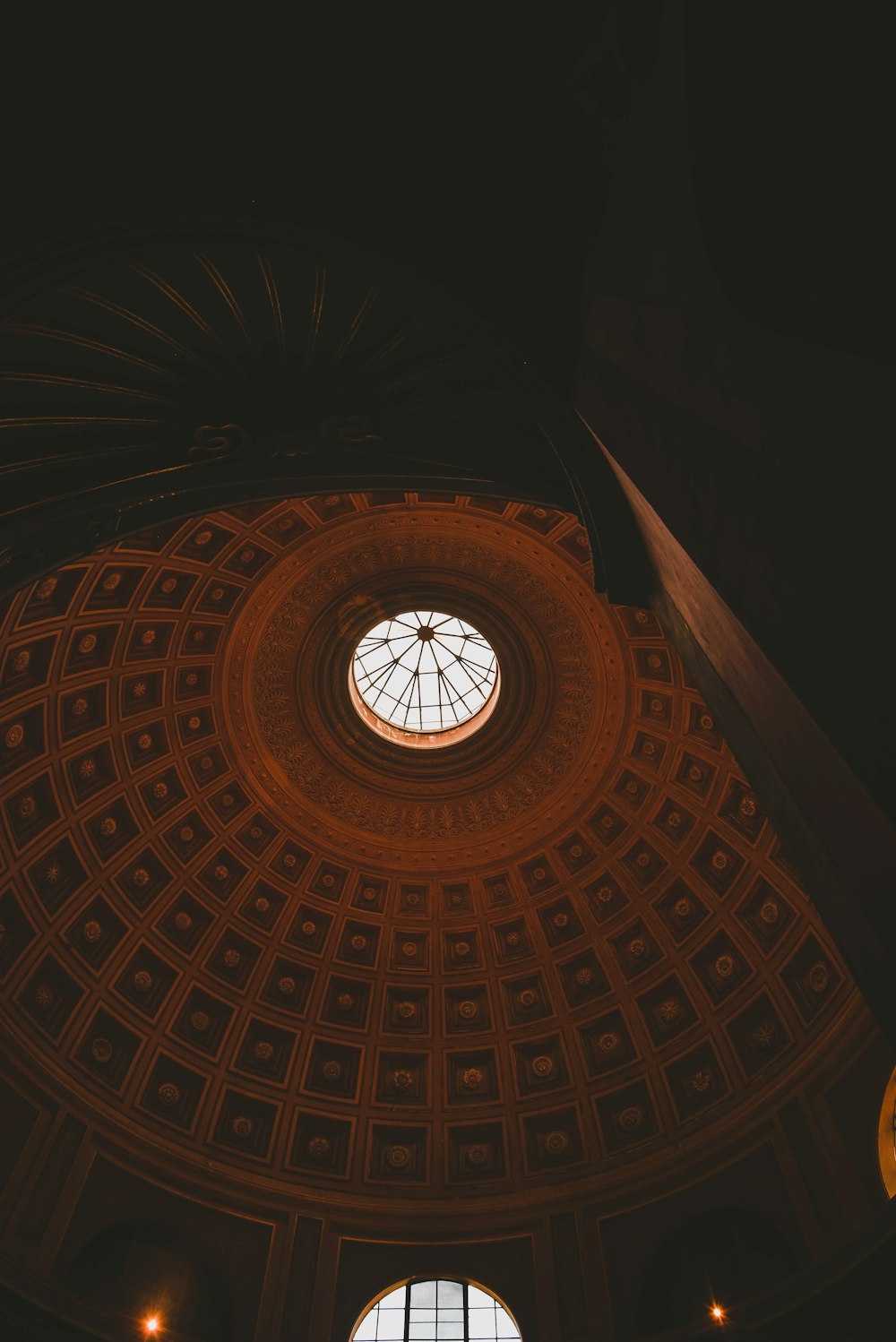 the ceiling of a building with a circular window