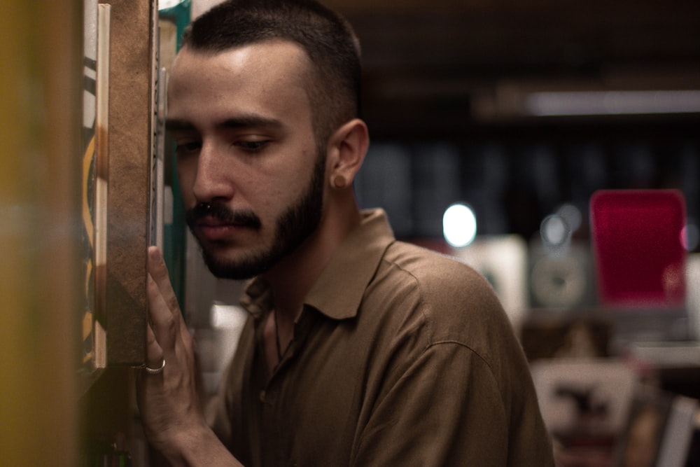 man wearing brown polo shirt