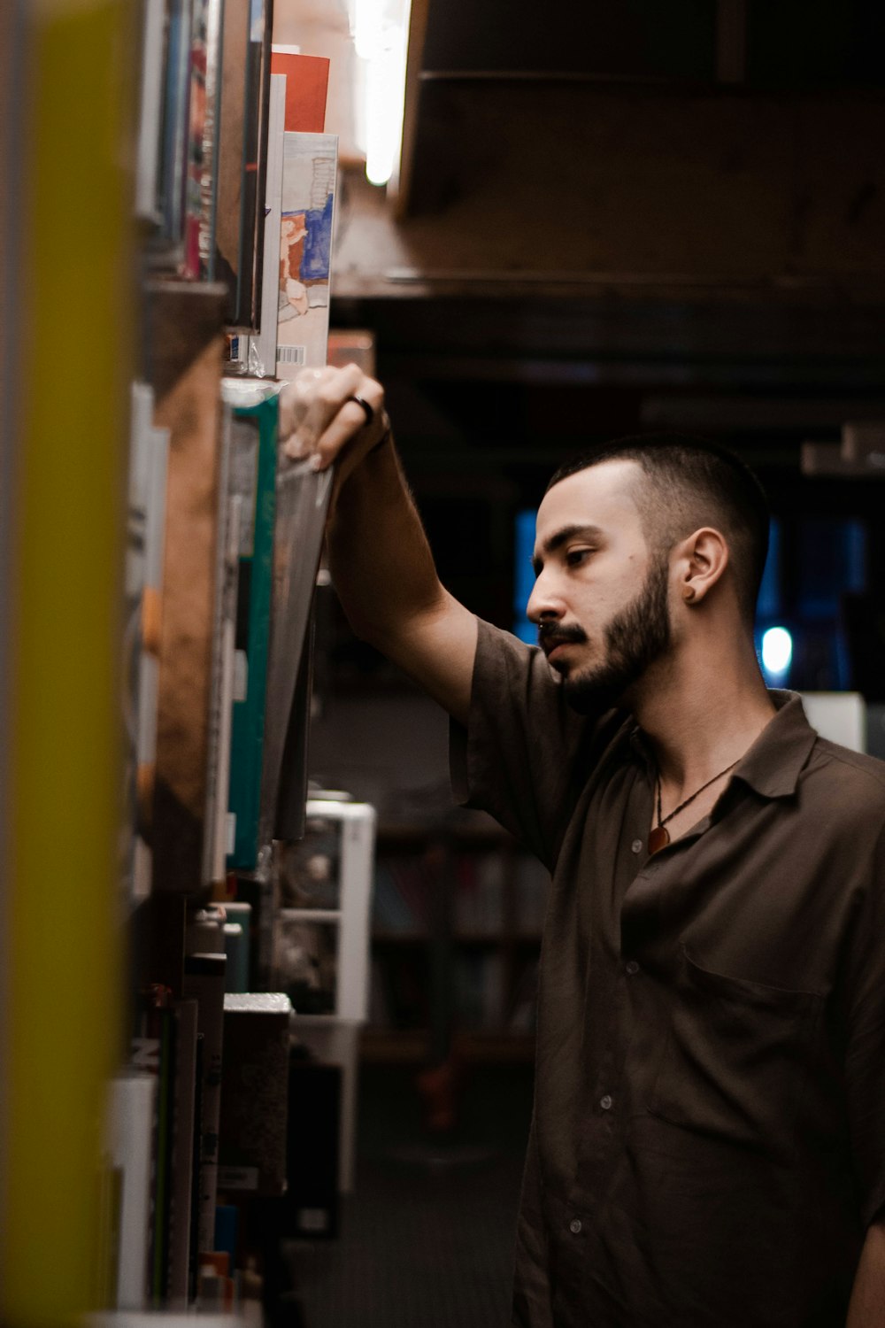 man picking books