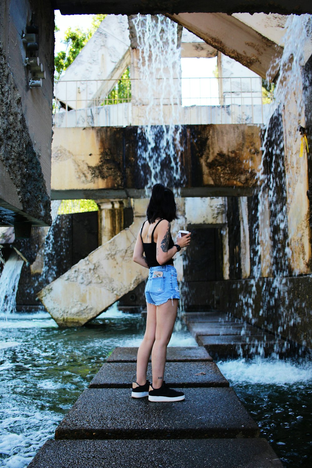 woman standing near falling water
