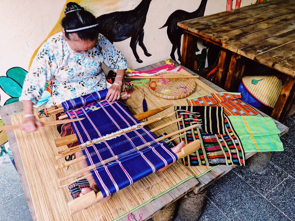 sewing woman sitting at the table