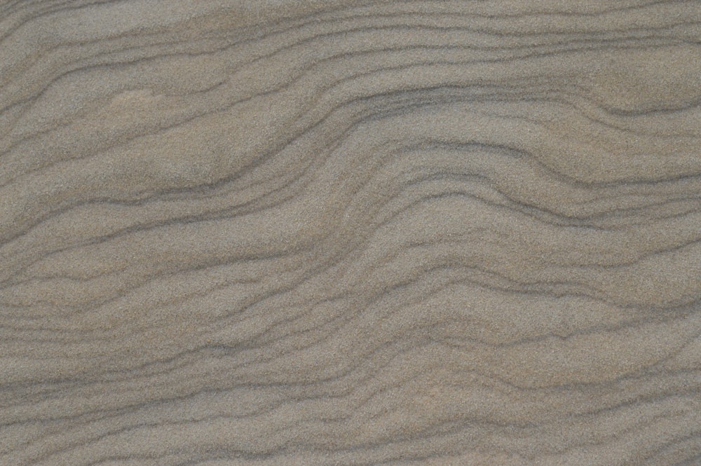 a close up of sand with wavy lines