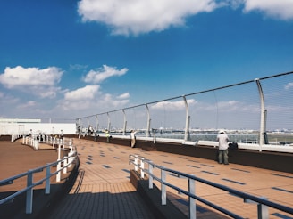 A cozy outdoor spotter deck overlooking planes taking off at Munich Airport during golden hour.