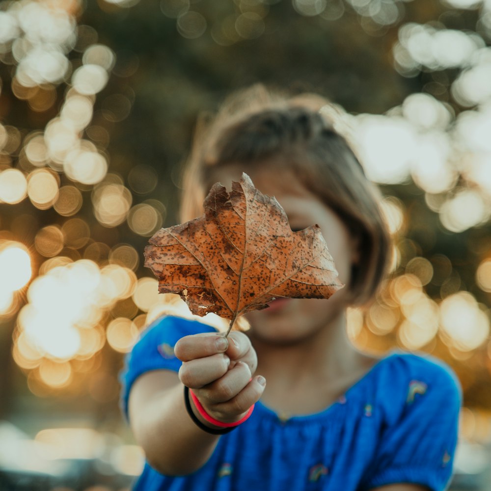 girl holding leaf