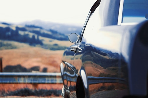 A shiny car parked in a scenic outdoor location.