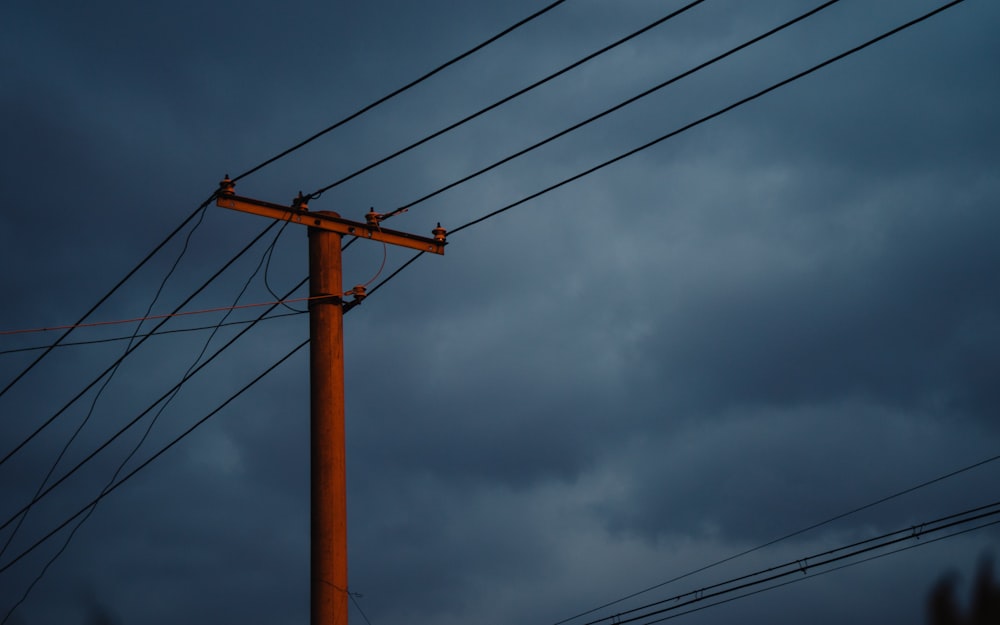 view of power lines under dark sky