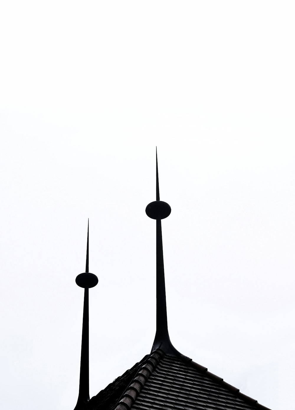 two black spires on top of a building