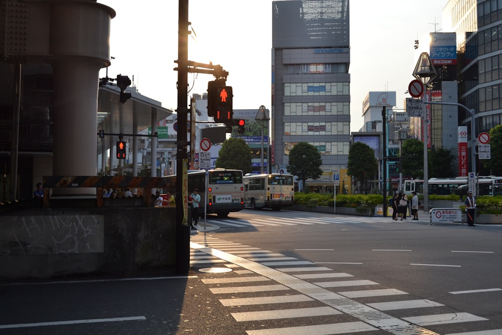 people walking near street and different vehicles on road viewing buildings during daytime