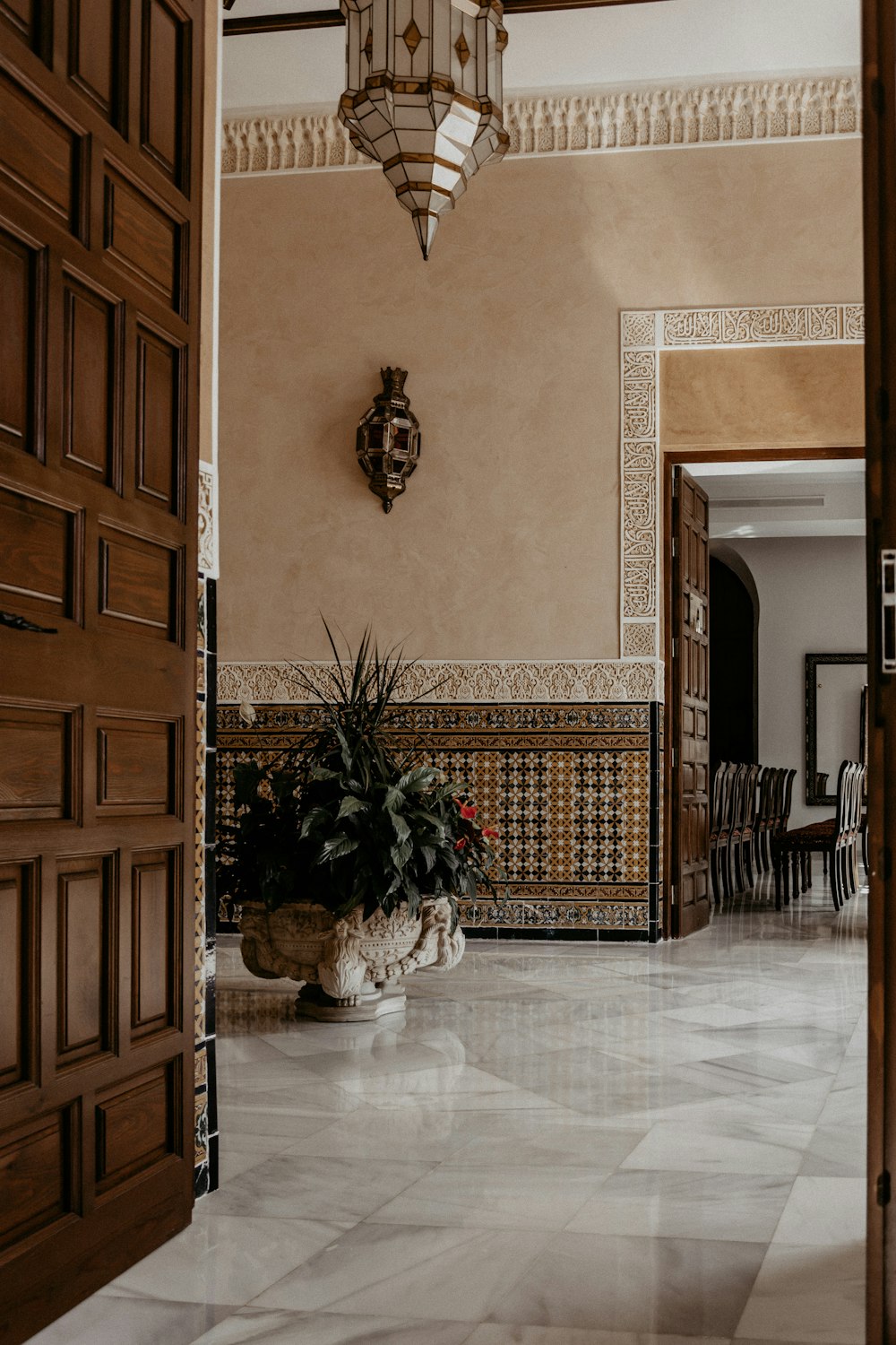 a large room with a potted plant on the floor