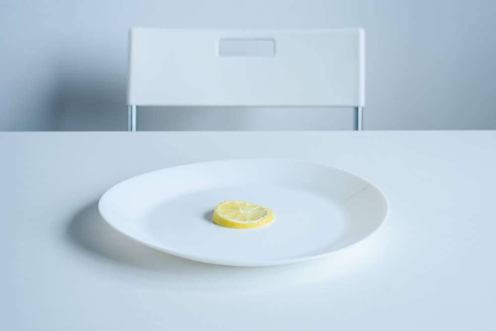 lemon sliced on round white ceramic plate